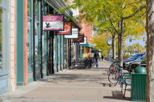 Fort Collins, Colorado, USA - October 15, 2013: Some of the restaurants and shops in Fort Collins, Colorado with people visible in the background. Situated at the foot of the Rocky Mountains, Fort Collins is a college town with a thriving downtown and has been voted by Money magazine to be one of the best towns to live in.