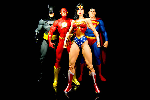 Super Team Vancouver, Canada - October 9, 2012: Action figure models of Wonder Woman, The Flash, Superman and Batman, released by DC comics, against a black background. action figure stock pictures, royalty-free photos & images