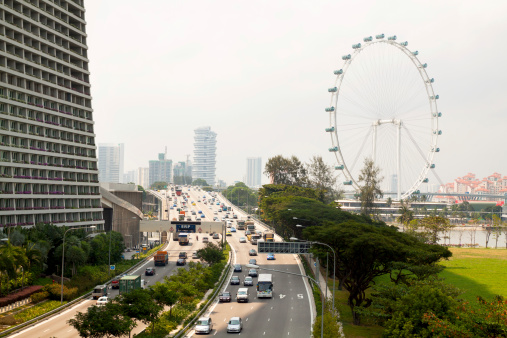 Singapore, Singapore - September, 3rd 2013: Aerial view of East Coast Parkway and city highway behind Marina Bay Sands. In background is landmark Singapore Flyer. On highway is ruling traffic.