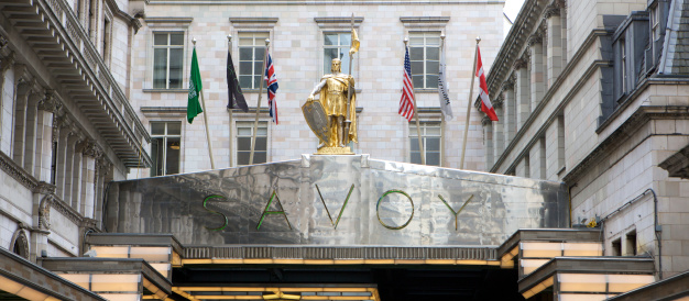 London, United Kingdom - April, 17th 2013: The front entrance of five star luxury London hotel The Savoy which is located on The Strand in central London. Opened in 1889, it is currently owned by Canadian based Fairmont Hotels and Resorts. The gilt statue of the knight is that of Peter, Count of Savoy.