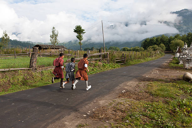 Kids running on main road to fire festival in Thangbi stock photo