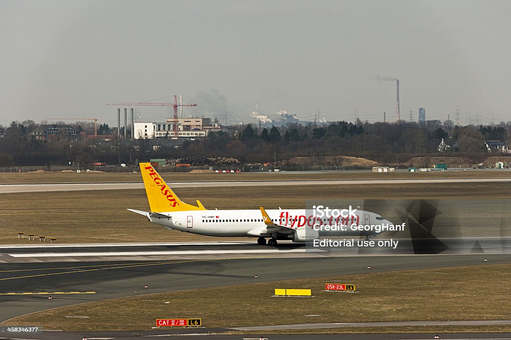 Boeing 737-800 Dusseldorf, Germany - April 1, 2013: A Boeing 737-800 of the A Boeing 737-800 of the Pegasus Airlines landing at the airport in Dusseldorf. Pegasus Airlines is a Turkish airline based in Istanbul, and based on the Istanbul-Sabiha Gak!Aaen Airport. Pegasus Airlines offers charter and scheduled flights to more than 70 locations in Europe and Asia. Air Vehicle Stock Photo