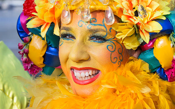 Portrait of smiling young Dutch woman wearing yellow carnival costume stock photo