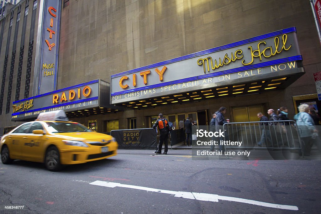 Radio City Music Hall NYC New York City, NY USA - December 2, 2011:  Yellow taxi drives by New York City landmark, Radio City Music Hall in Rockefeller Center on Dec. 2, 2011. Radio City is home of the Rockettes and annual Christmas Spectacular. Christmas Stock Photo
