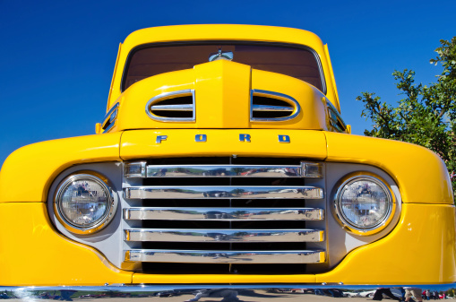 Westlake, Texas, USA - October 27, 2012: A yellow 1949 Ford F1 pickup truck is on display at the 2nd Annual Westlake Classic Car Show. Front view details.