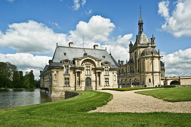 Chantilly, France- May 12, 2012: Chateau de Chantilly ( Chantilly Castle ), located in the town of Chantilly, France. The Chateau consists of two buildings: Petit Chateau (built in 1560) and Grand Chateau (was destroyed during the French Revolution and rebuilt in 1870). The Chateau is Musee Conde - one of the best art galleries in France