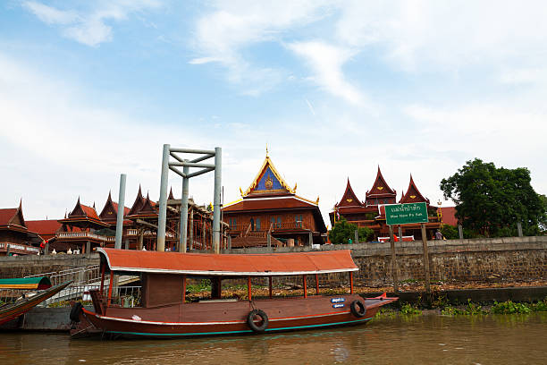 Pier of Wat Phanan Choeng Ayutthaya, Thailand - July, 6th 2013: Pier of Wat Phanan Choeng with boats seen from river Chao Praya. Some people are visiting temple. Temple is from 14th century and seated at riverside of Chao Praya. wat phananchoeng stock pictures, royalty-free photos & images