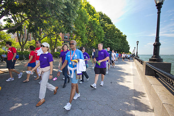 Liver Life Walkathon New York City, NY, USA - June 3, 2012: Participants gather for annual Liver Life Walk from Battery Park in New York City on June 3, 2012. American Liver Foundation hosts this 3 mile walk to raise money each year. walking for a cause stock pictures, royalty-free photos & images