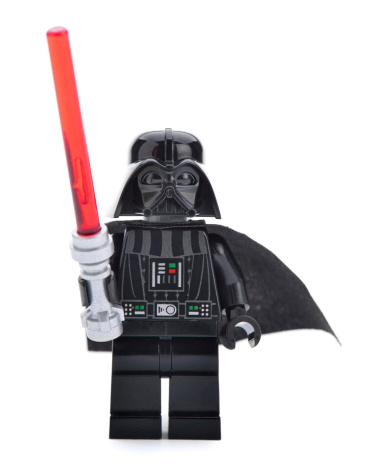 Ankara, Turkey - April 06, 2013: Close- up of a Lego Darth Vader minifigure with sword isolated on white background