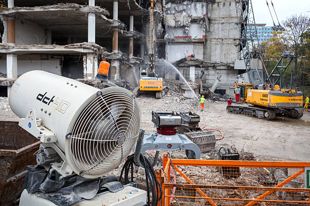 Demolition site using water misting to control dust and ensure safe teardown