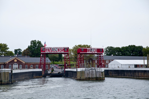 New York City, USA - August 18, 2013: Entrance of Governors Island in New York City.  Governors Island is an island in Upper New York Bay, approximately one-half mile (1 km) from the southern tip of Manhattan Island and separated from Brooklyn by Buttermilk Channel. It is legally part of the borough of Manhattan in New York City.