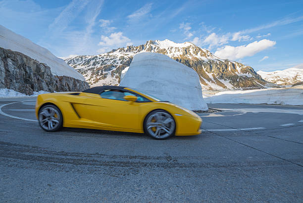 Yellow lamborghini car in a hairpin turn stock photo