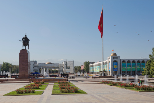 Bishkek, Kyrgyzstan - September 7, 2013: Ala-Too Square is the central square in Bishkek, Kyrgyzstan. The square was built in 1984 to celebrate the 60th anniversary of the Kyrgyz SSR. A statue called Erkindik (Freedom) is at the center of square. And local people of the city can be seen in the image.