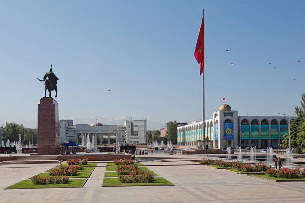 Ala-Too Square, Bishkek, Kyrgyzstan Bishkek, Kyrgyzstan - September 7, 2013: Ala-Too Square is the central square in Bishkek, Kyrgyzstan. The square was built in 1984 to celebrate the 60th anniversary of the Kyrgyz SSR. A statue called Erkindik (Freedom) is at the center of square. And local people of the city can be seen in the image. bishkek stock pictures, royalty-free photos & images