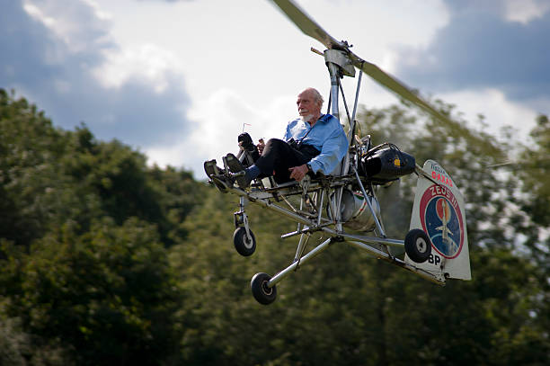 Reymerston, Norfolk, England, August 22, 2009, Wing Commander Ken Wallis, piloting an autogiro in the air from his personal landing strip at his home in Reymerston, Norfolk