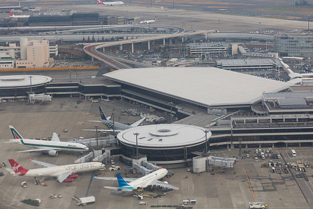 Narita International Airport in Japan Narita, Japan - November 29, 2012 : Airplanes parked at the Narita International Airport, Chiba, Japan. It is the second busiest airport in Japan. narita japan stock pictures, royalty-free photos & images