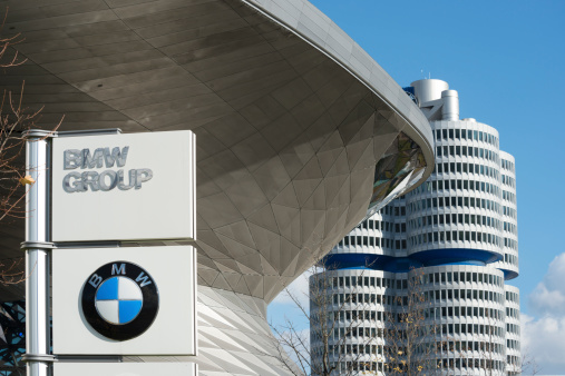 Munich, Germany - November 5, 2013: BMW Tower in Munich, here is the headquarter of the BMW Group located.. The architect was Karl Schwanzer from Vienna and it was constructed in 1972. The building in front is the BMW Welt an event forum, showroom and conference center. It was opened in 2007.