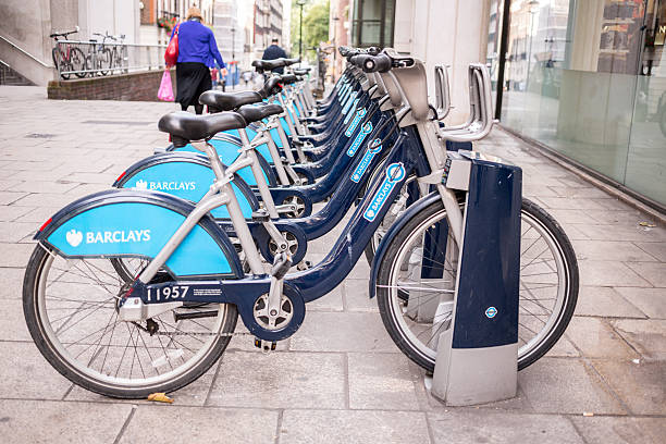 Public Bikes in London London, England - September 26, 2013: City-owned bicycles racked up and ready for commuters to rent near Charing Cross Station boris bus stock pictures, royalty-free photos & images
