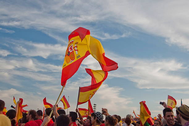 Spanish flags flutter above unidentified fans. stock photo