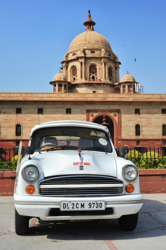 Delhi, India - September 18, 2013: an offically used old style car is parking before Indian Government building.
