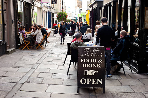 London, UK - September 29, 2013: people enjoy an outdoor lunch at the Angel in Islington. The district of Angel, Islington has one of the highest densities of bars and restaurants in central London.