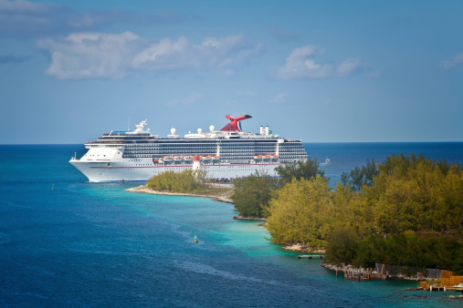 Nassau, Bahamas - Jan. 13, 2013:  Carnival cruise ship, Miracle, enters the port of Nassau, Bahamas.  The island of the Bahamas is most notably one of the most popular Caribbean cruise locations.