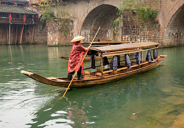 Fenghuang, China - October 29, 2012: Empty tourist boat in Tuojiang river, ancient town Fenghuang (Phoenix), Hunan province, China.