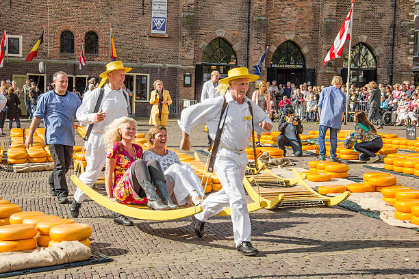 Carriers in the famous Alkmaar cheese market Alkmaar, The Netherlands - September 7 2012: Carriers organizing the famous Dutch cheese market in Alkmaar. cheese dutch culture cheese making people stock pictures, royalty-free photos & images