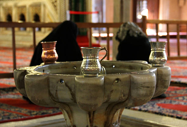 Edirne, Turkey - October 7, 2012:  there is an islamic water tank with a fountain and Muslim women prays in selimiye mosque in edirne ,Turkey