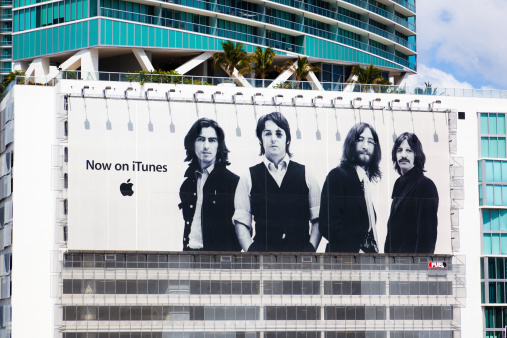Miami, Florida, USA - March 19, 2011: a large Apple billboard hanging on a building in Downtown Miami shows that The Beatles music band is now on sale on iTunes.