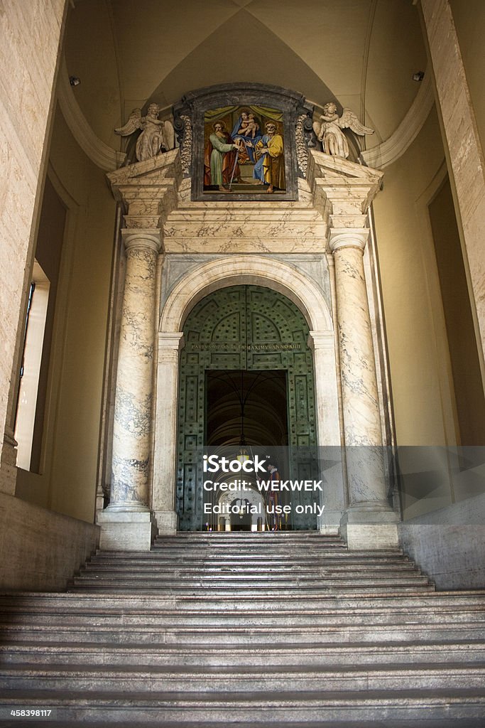 Swiss Guard at the side entrance of St. Peter's Basilica. VATICAN CITY, VATICAN - August 15th 2010: Swiss Guard standing firm at the side entrance of Saint Peter\'s Basilica. Adult Stock Photo