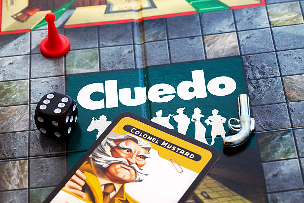 Cluedo board game London, England - May 1, 2011: central part of the board game Cluedo with a dice, colonel mustard playing card, revolver token and Miss Scarlett red playing piece. Cluedo is a popular murder mystery game of deduction with the aim to discover who the murderer was, with what weapon and in what room. murder mystery stock pictures, royalty-free photos & images