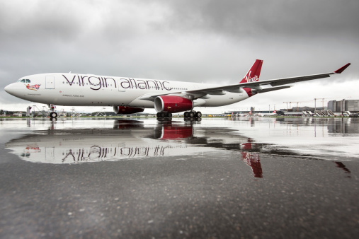 ZArich, Switzerland - April 27, 2013: Airbus A330-300 of Virgin Atlantic Airways in brilliant lighting conditions shortly after a rain shower with reflections on the ramp at Zurich airport.
