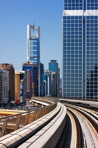 Dubai, UAE - May 9, 2010: Curvy Dubai Metro line runs sum 40 km along Sheikh Zayed Road between glorious skyscrapers