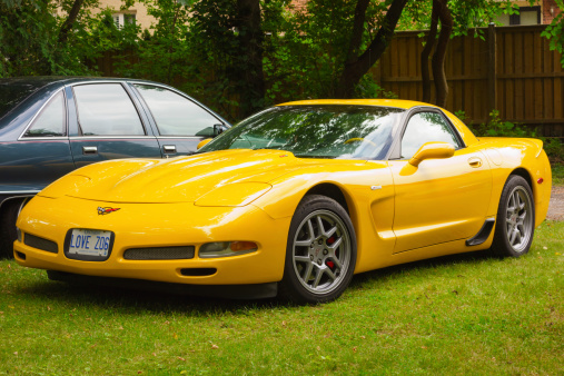 Toronto, Canada - August 31, 2013:  Yellow colored Chevrolet Corvette C5 Z06 high-performance sports car parked on a lawn.