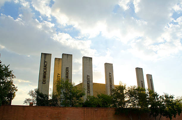 The Apartheid Museum Johannesburg, South Africa. Johannesburg, South Africa - April 5, 2012: . Various, stark concrete pillars at the entrance to the Apartheid Museum, depicting the words: responsibility, reconciliation, equality, diversity, responsibility diversity and respect. apartheid sign stock pictures, royalty-free photos & images