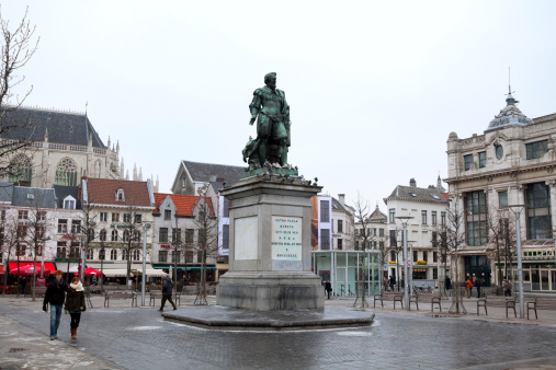 Antwerpen, Belgium - February, 9th 2012: Statue of artist and painter Peter Paul Rubens in Antwerpen. Statue is seated on square Groenplaats. Winter shot, some people are passing square.
