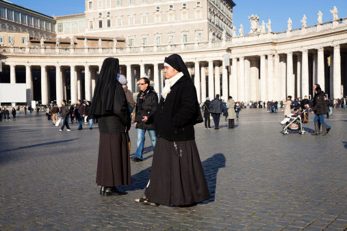 Vatican City, Vatican - December, 30 2010: Nuns visiting St Peter's Square on a sunny winter day, Vatican City State.