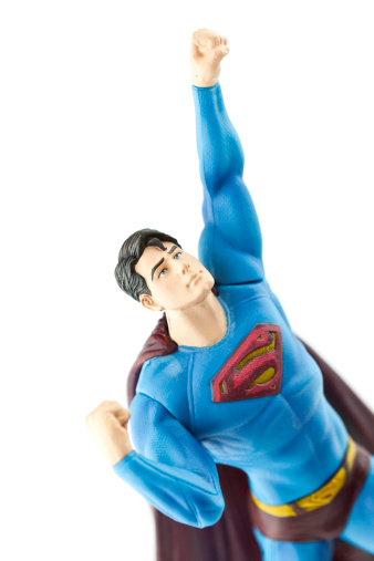 Suffolk, Virginia, USA - April 13, 2011: A studio shot of the cartoon Superhero character Superman, which is owned by DC comics and Warner Bros. This toy was created by the Mattel toy company, and shows Superman reaching towards the skies.