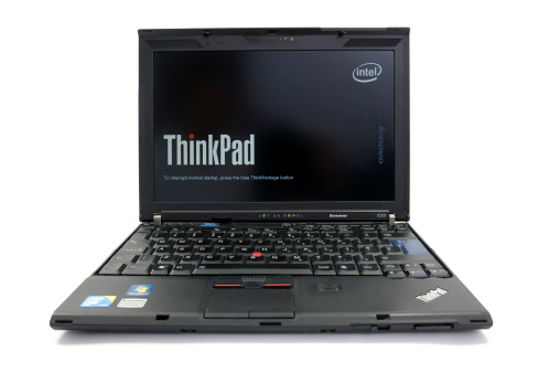 Newcastle upon Tyne, United Kingdom - June 8, 2011: Lenovo Thinkpad X201 Notebook. Start up screen showing ThinkPad and Intel Logo. Sitting on a white background.
