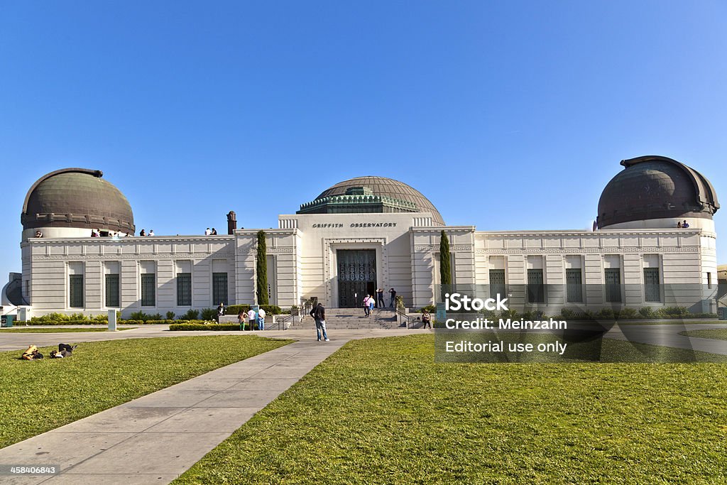 famous Griffith observatory in Los Angeles Los Angeles, USA - June 10, 2012: famous Griffith observatory in Los Angeles. The famous observatory is open to public without entrance fee due to the will of Mr. Griffith testament. People enjoy the famous view to Los Angeles from the observatory. Architectural Dome Stock Photo