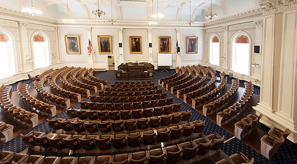 New Hampshire Legislative chamber Concord, NH, USA - October 11, 2013: The New Hampshire House Chamber houses the largest state legislative body in the United States, with 400 members.  Portraits of John P. Hale, Abraham Lincoln, George Washington, Franklin Pierce, and Daniel Webster line the rear wall. concord new hampshire stock pictures, royalty-free photos & images