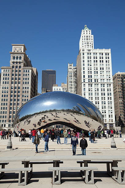 Chicago, USA; April 29th 2011: Tourists at Millennium Park which is one of the most popular sites of downtown Chicago with the Cloud Gate Sculpture