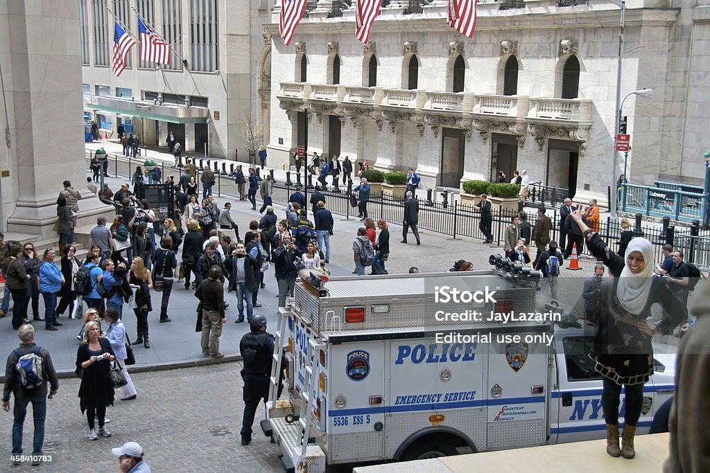 NYPD ESU Officer, Vehicle, Federal Hall, Wall Street, NYC New York City, USA - March 18, 2011: New York Police Department -NYPD Emergency Service Division officer stands watch besides his vehicle parked in front of the historic Federal Hall along Wall Street. Thousands of tourists each day come to the location to look at the historic site of the New York Stock Exchange, seen the background. The anti terrorist security measures were put in place after the events of September 11, 2001 in lower Manhattan. SWAT Team Stock Photo