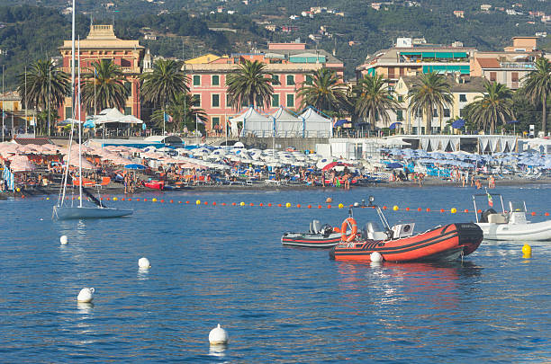 Lavagna, Italy - September 4, 2013: Holidaymakers - specifically people soaking up the last rays of sun on a late afternoon in Lavagna on the Italian Riviera.