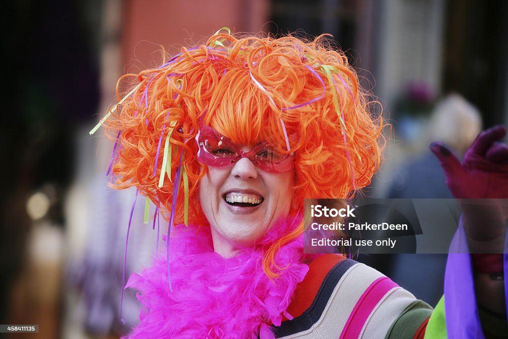 Woman in Festive Costume at Mardi Gras New Orleans, LA New Orleans, LA, USA- Feb 15, 2010:  Woman in New Orleans French Quarter at Mardi Gras in colorful festive costume waves to the crowd. Adult Stock Photo