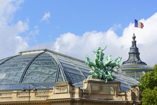 Paris, France - August 18, 2013: the Grand Palais des Champs-ElysAes is a building in Beaux-Arts architecture style. It was built for Universal Exposition of 1900 and made of glass, iron, steel and concrete. It rises on the Champs-ElysAes Boulevard near pont Alexandre III and the Petit Palace in Paris, France.