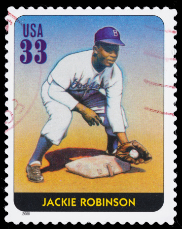 Sacramento, California, USA - March 28, 2011: A 2000 USA postage stamp with an illustration by artist Joe Saffold of Jackie Robinson (1919-1972) fielding a baseball. Robinson was the first African-American to play in the modern Major Leagues. The stamp was created using a muted color palette to resemble vintage baseball cards.