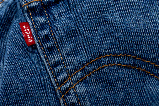 San Diego, California, United States - March 23rd 2011: This is a closeup photo of a back pocket on a pair of 501 Levis Jeans. It was originally founded in 1853. Levis has a patent on the back pocket double arch stitch pattern.