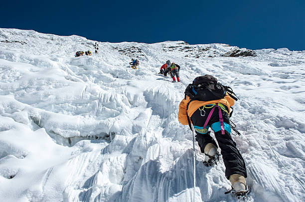 Ice climbing Island Peak,Nepal-April 07,2012:The Climbers climbing the ice wall to the top of Island Peak (Imja Tse) summit(6189m) in the Himayalas Everest region,Nepal. climbing stock pictures, royalty-free photos & images